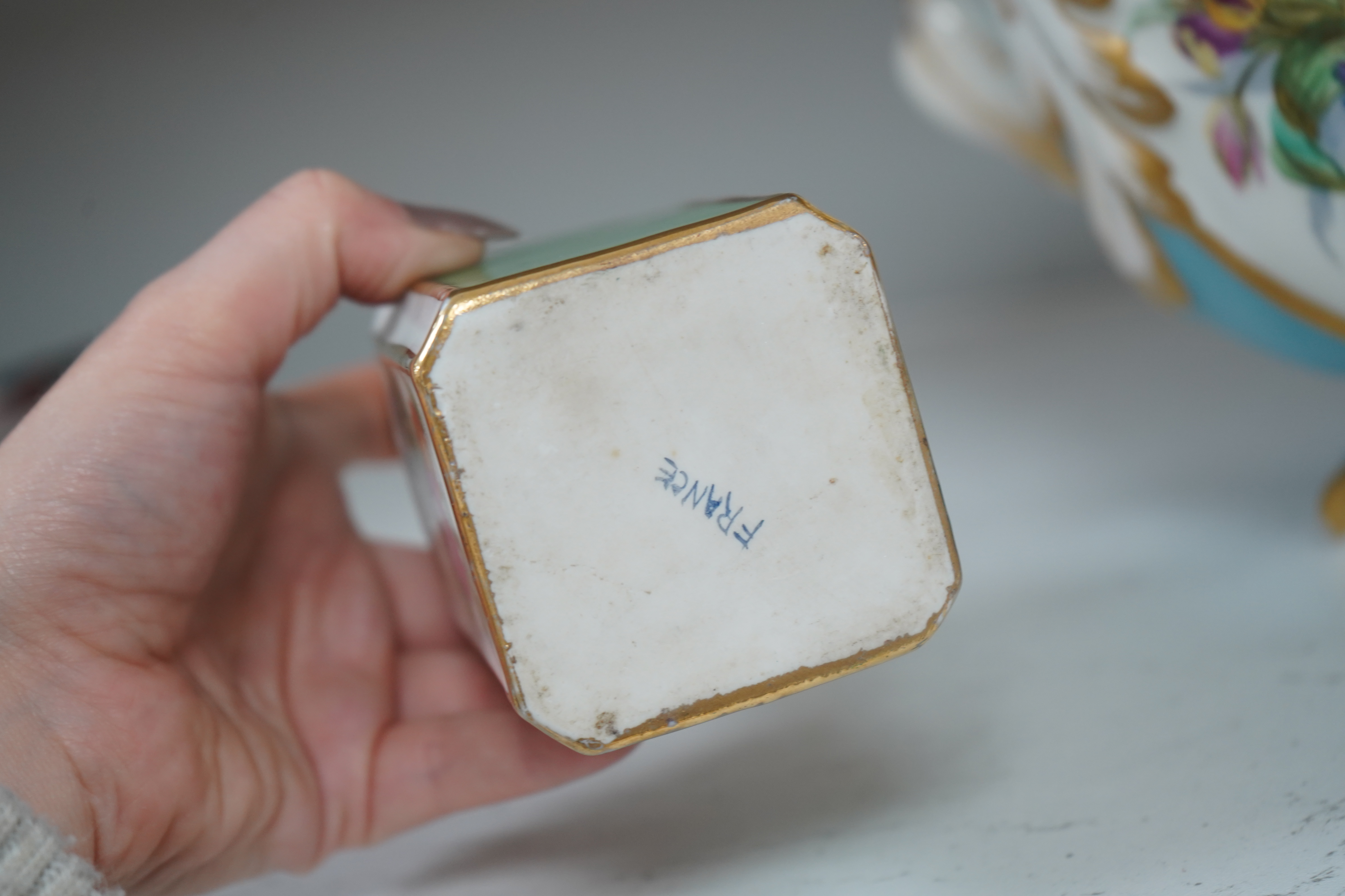 A Sevres style flower painted navette shaped jardiniere and a similar French scent bottle and stopper, late 19th century, largest 38cm wide. Condition - fair to good